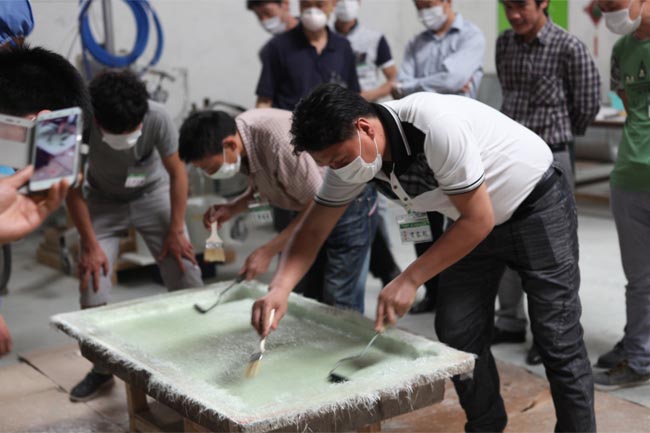 噴涂完成后，用輥筒壓實玻纖